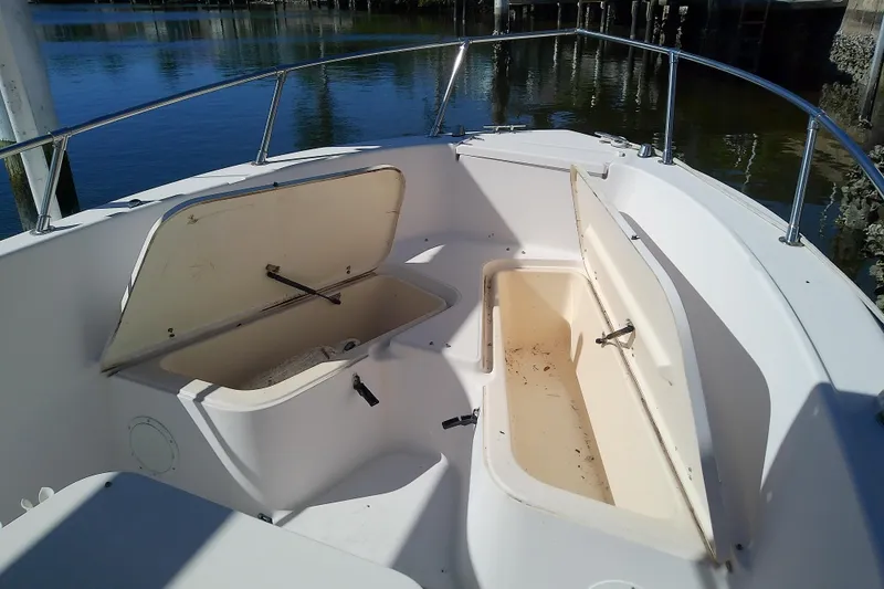 Slide: The Image of 1999 Grady-White Escape 209 boat with open storage compartments on deck. - 28