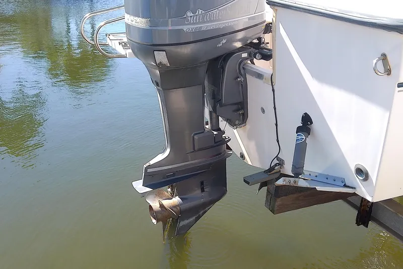 Slide: The Image of 1999 Grady-White Escape 209 boat with outboard motor on calm water. - 6