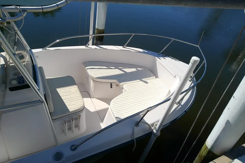Slide: The Image of 1999 Grady-White Escape 209 boat interior with cushioned seating and railing. - 9
