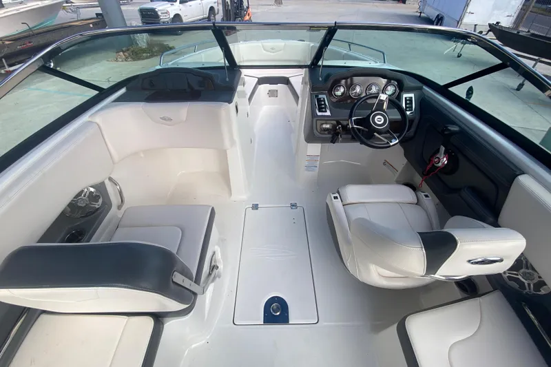 Slide: The Image of 2017 Chaparral 227 SSX boat interior with white seating and modern dashboard. - 17