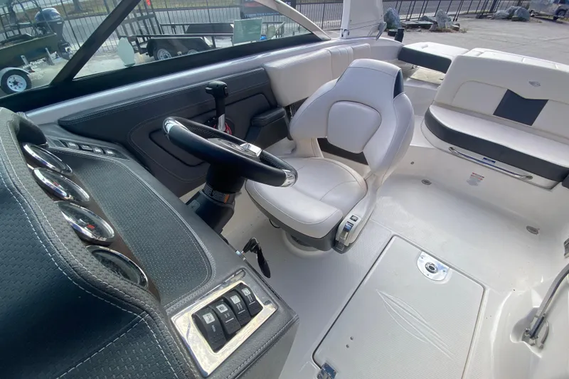 Slide: The Image of 2017 Chaparral 227 SSX boat interior with steering wheel and seating area. - 19