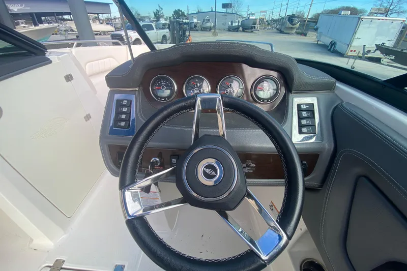 Slide: The Image of 2017 Chaparral 227 SSX boat dashboard with steering wheel and gauges. - 21