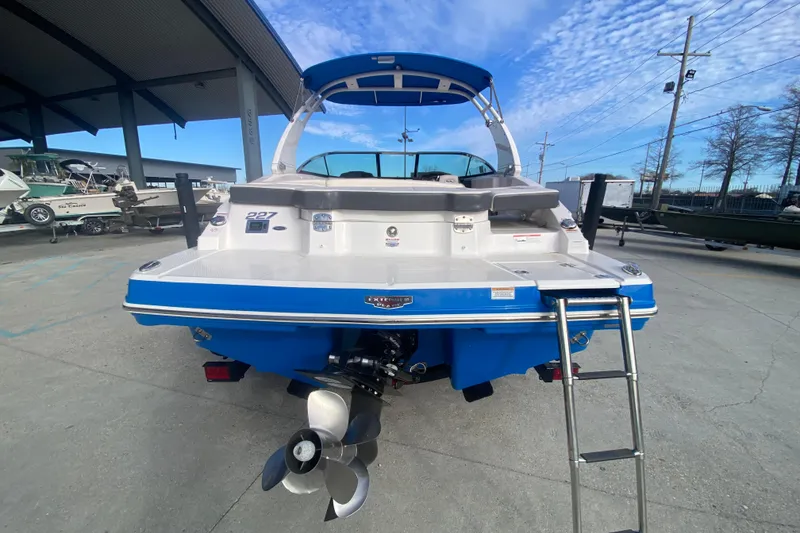 Slide: The Image of 2017 Chaparral 227 SSX boat, rear view with ladder and propeller, under blue sky. - 4
