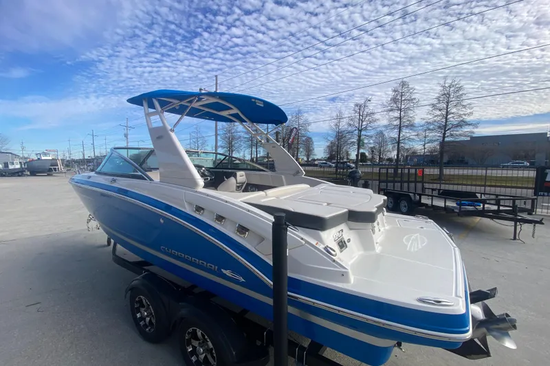 Slide: The Image of 2017 Chaparral 227 SSX boat with blue and white design on a trailer. - 6