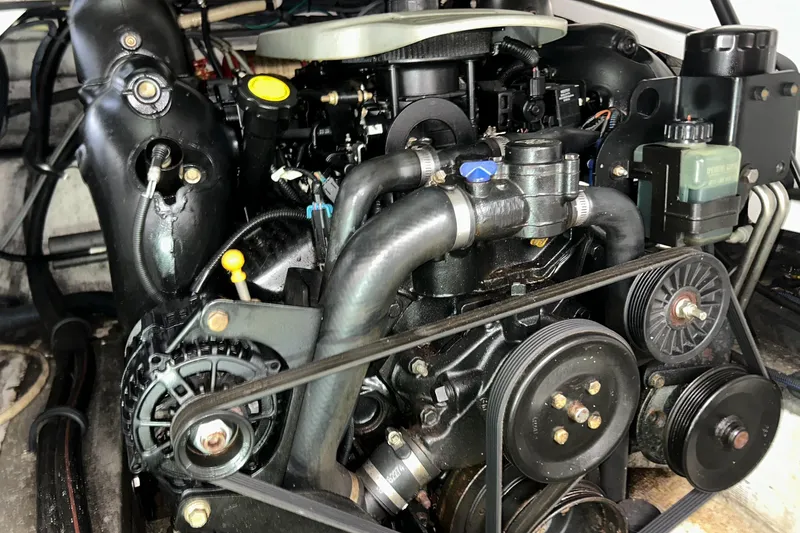 Slide: The Image of Engine of a 2015 Cruisers Sport Series 258 Bow Rider boat, showcasing mechanical components. - 10