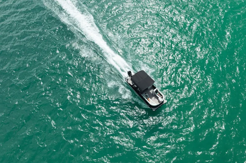 Slide: The Image of Aerial view of Harris Sunliner 230 boat on turquoise water, 2026 model. - 6