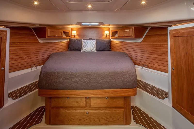 Slide: The Image of Manufacturer Provided Image: Luxurious cabin interior of 2026 Back Cove 39O yacht with wooden accents and cozy bedding. - 11
