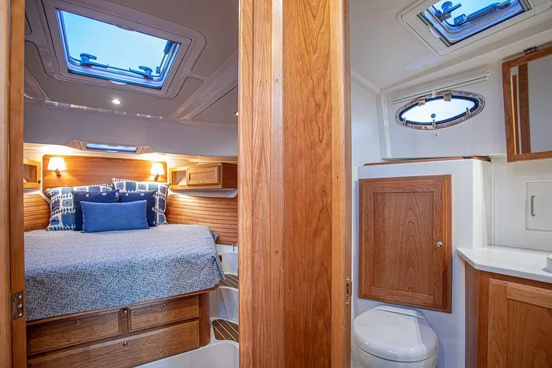 Slide: The Image of Manufacturer Provided Image: Luxurious cabin interior of 2026 Back Cove 39O yacht with cozy bed and modern bathroom. - 12