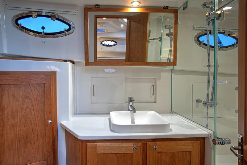 Slide: The Image of Manufacturer Provided Image: Luxurious bathroom in 2026 Back Cove 39O yacht with modern fixtures and wooden cabinetry. - 13