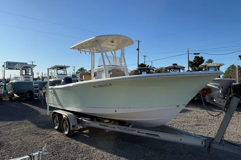 Slide: The Image of 2018 Sea Hunt Ultra 225 boat on trailer in outdoor lot. - 11
