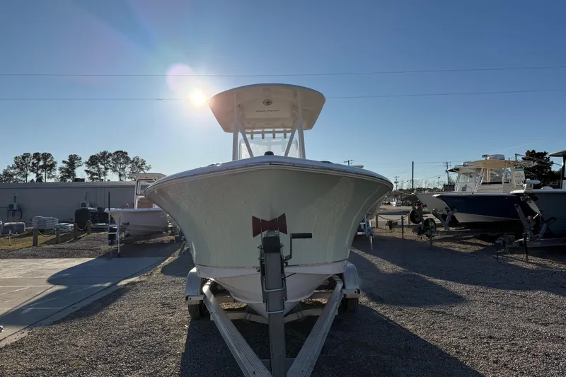 Slide: The Image of 2018 Sea Hunt Ultra 225 boat on trailer under clear blue sky. - 12