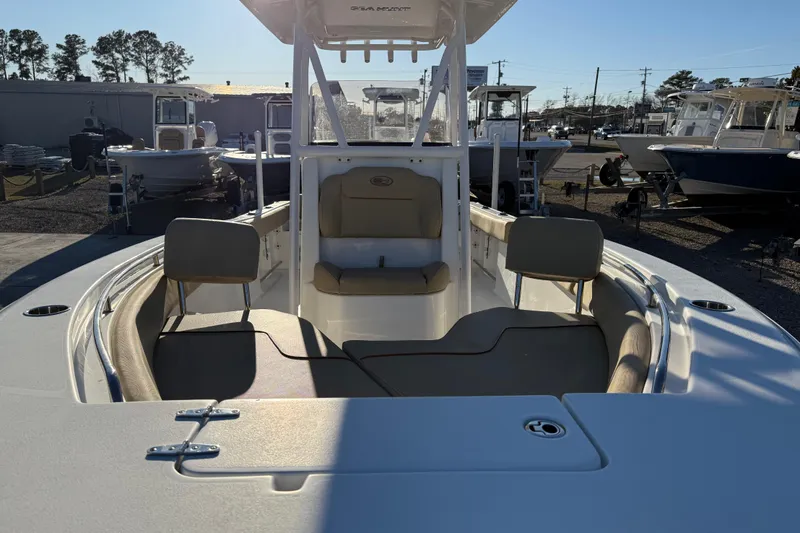 Slide: The Image of 2018 Sea Hunt Ultra 225 boat interior with seating and console, displayed outdoors. - 13