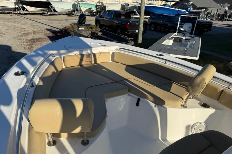Slide: The Image of 2018 Sea Hunt Ultra 225 boat with beige seating in a marina setting. - 14