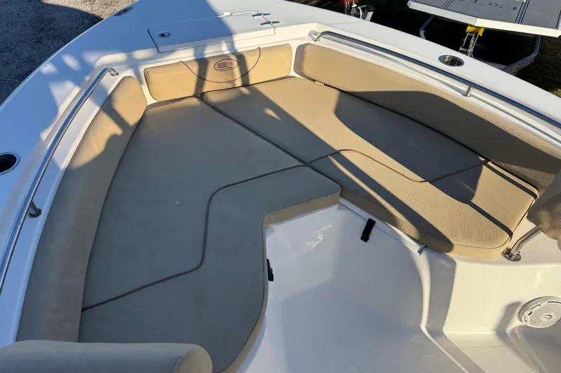 Slide: The Image of 2018 Sea Hunt Ultra 225 boat interior with beige seating and stainless steel railings. - 15