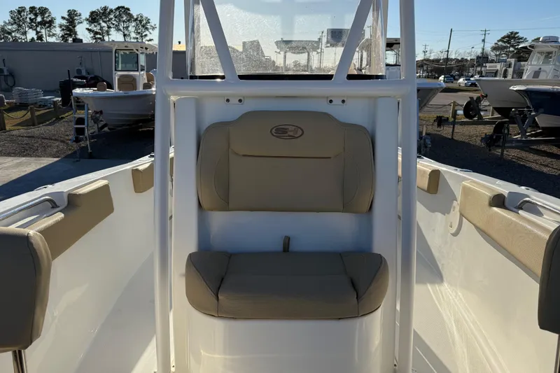 Slide: The Image of 2018 Sea Hunt Ultra 225 boat interior with beige seating and console. - 17