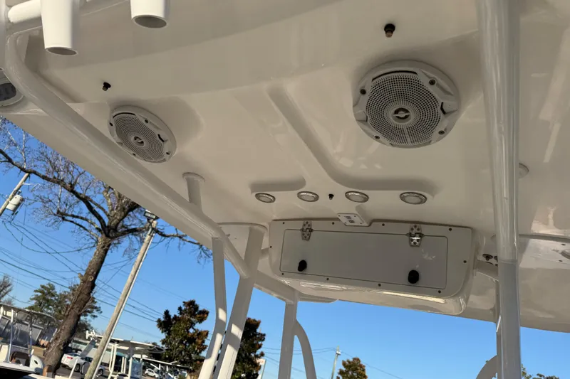 Slide: The Image of 2018 Sea Hunt Ultra 225 boat ceiling with speakers and rod holders. - 23