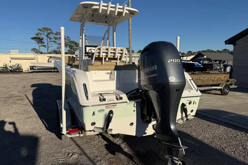 Slide: The Image of 2018 Sea Hunt Ultra 225 boat with Yamaha 200 engine, parked outdoors. - 5