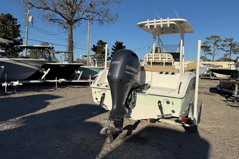 Slide: The Image of 2018 Sea Hunt Ultra 225 boat with Yamaha 200 engine, parked on gravel lot. - 6
