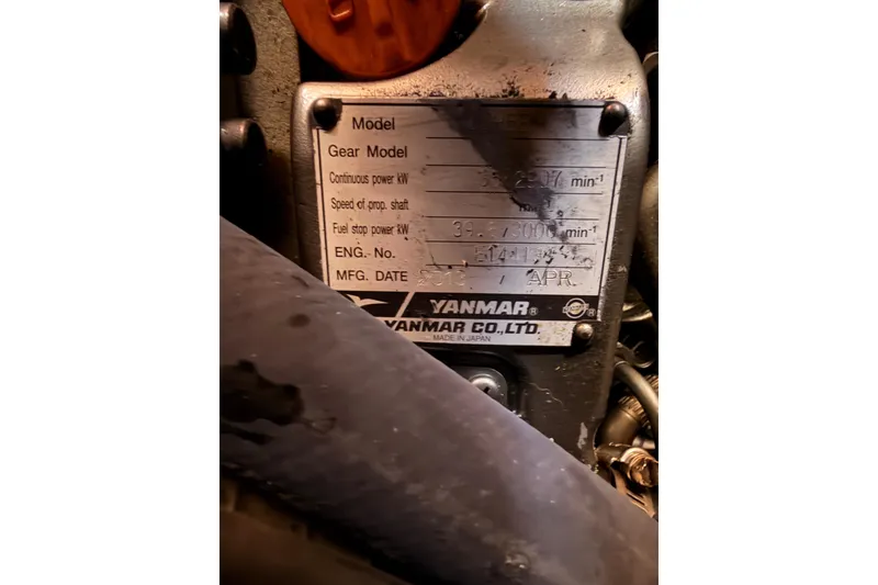 Slide: The Image of Yanmar engine plate on 2014 Jeanneau Sun Odyssey 469 sailboat, displaying specifications and manufacturing details. - 102