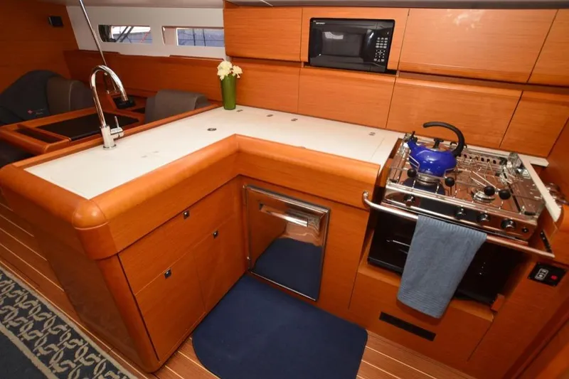 Slide: The Image of 2014 Jeanneau Sun Odyssey 469 sailboat deck with hatch and railing at marina. - 16