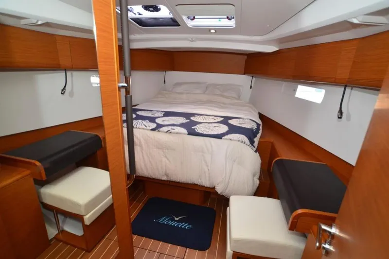 Slide: The Image of 2014 Jeanneau Sun Odyssey 469 sailboat cockpit with teal seating and dual steering wheels. - 26