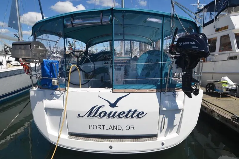 Slide: The Image of 2014 Jeanneau Sun Odyssey 469 yacht docked in a marina with palm trees. - 3