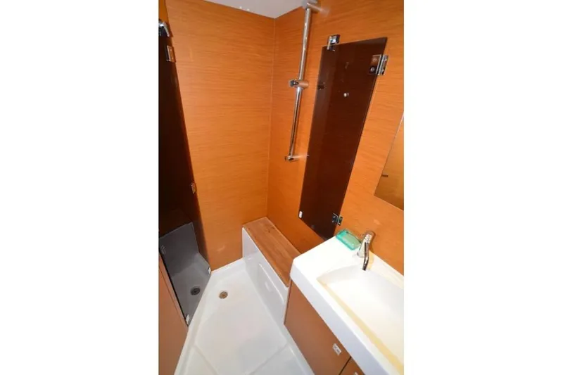 Slide: The Image of Cockpit of 2014 Jeanneau Sun Odyssey 469 with teak flooring and water view. - 30
