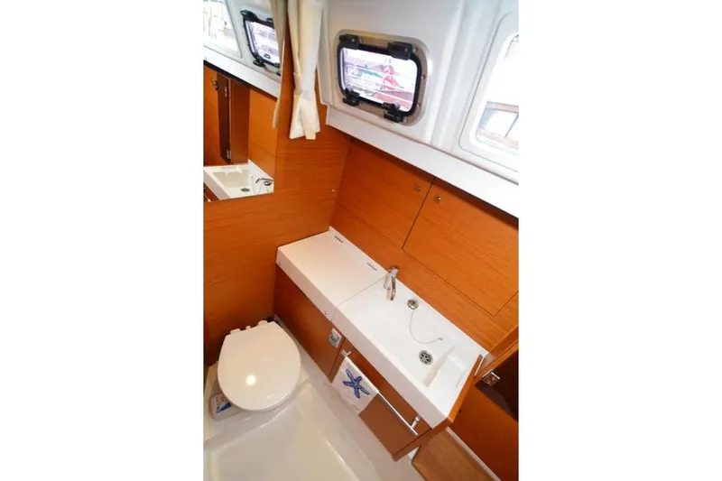 Slide: The Image of Cockpit of 2014 Jeanneau Sun Odyssey 469 sailboat with dual steering wheels and teak flooring. - 34