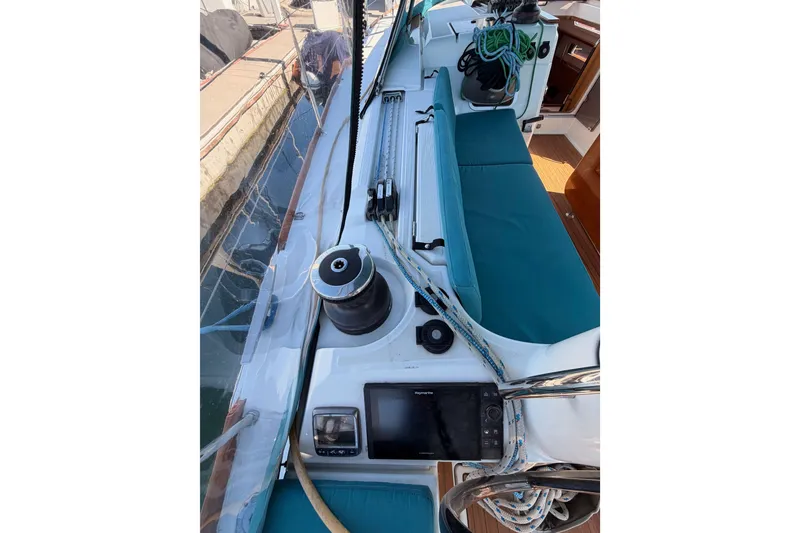 Slide: The Image of 2014 Jeanneau Sun Odyssey 469 sailboat deck with winch, ropes, and navigation equipment. - 37
