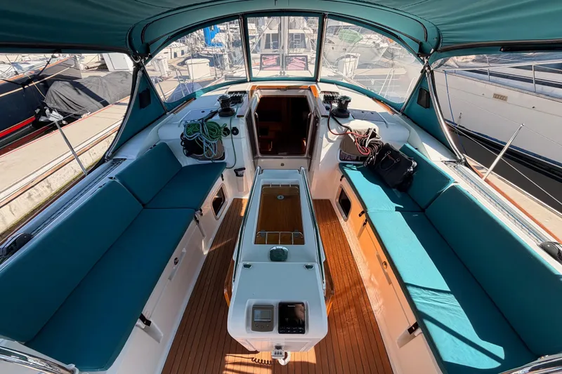 Slide: The Image of 2014 Jeanneau Sun Odyssey 469 yacht cockpit with teal seating and wooden flooring. - 42