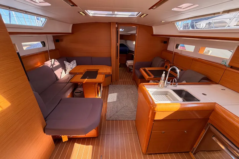 Slide: The Image of Interior of 2014 Jeanneau Sun Odyssey 469 yacht with modern kitchen and seating area. - 47