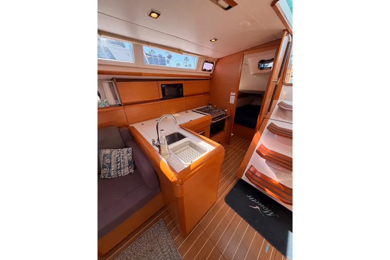 Slide: The Image of Interior of 2014 Jeanneau Sun Odyssey 469 sailboat with kitchen and seating area. - 49