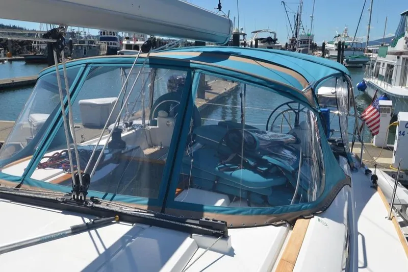Slide: The Image of 2014 Jeanneau Sun Odyssey 469 sailboat docked in a marina under clear blue skies. - 5