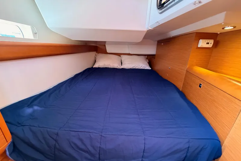 Slide: The Image of Cozy cabin interior of 2014 Jeanneau Sun Odyssey 469 with blue bedding. - 55