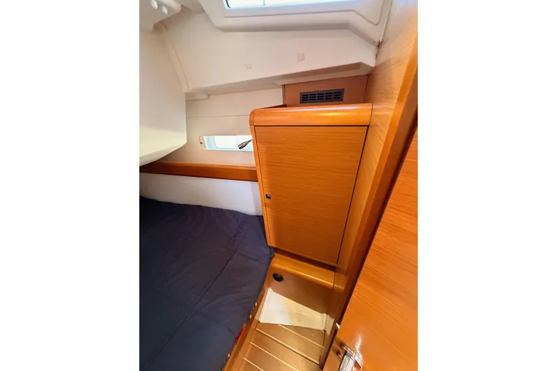 Slide: The Image of Interior cabin of 2014 Jeanneau Sun Odyssey 469 sailboat, featuring wooden cabinetry and bedding. - 64