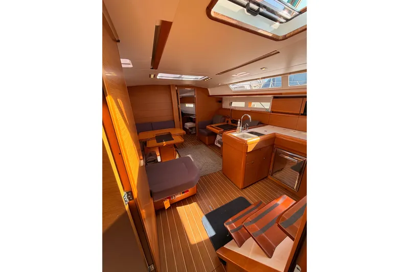 Slide: The Image of Interior of 2014 Jeanneau Sun Odyssey 469 yacht, featuring modern kitchen and seating area. - 65