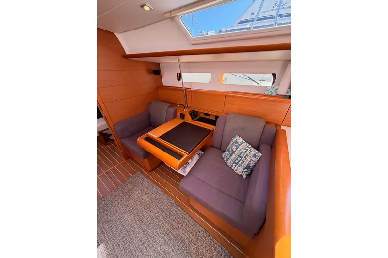 Slide: The Image of 2014 Jeanneau Sun Odyssey 469 interior with cozy seating and wooden table. - 73