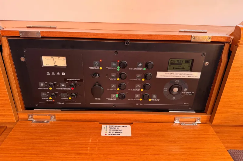 Slide: The Image of Control panel of 2014 Jeanneau Sun Odyssey 469 sailboat, featuring various switches and gauges. - 77