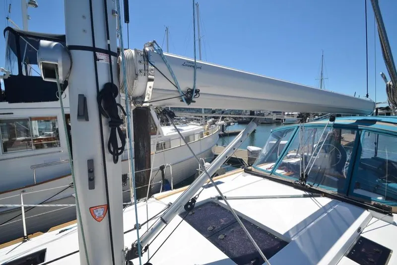 Slide: The Image of 2014 Jeanneau Sun Odyssey 469 sailboat docked in a marina under clear blue skies. - 8