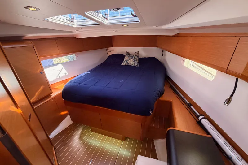 Slide: The Image of Luxurious cabin interior of 2014 Jeanneau Sun Odyssey 469 yacht with cozy bed and wooden finish. - 84