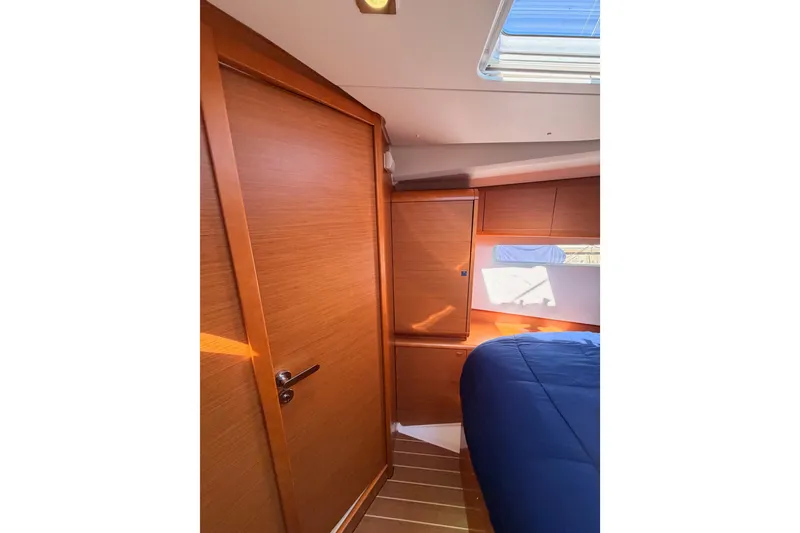 Slide: The Image of Interior cabin of 2014 Jeanneau Sun Odyssey 469, featuring wood paneling and a skylight. - 85