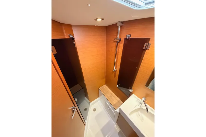 Slide: The Image of 2014 Jeanneau Sun Odyssey 469 bathroom with wood paneling and modern fixtures. - 87