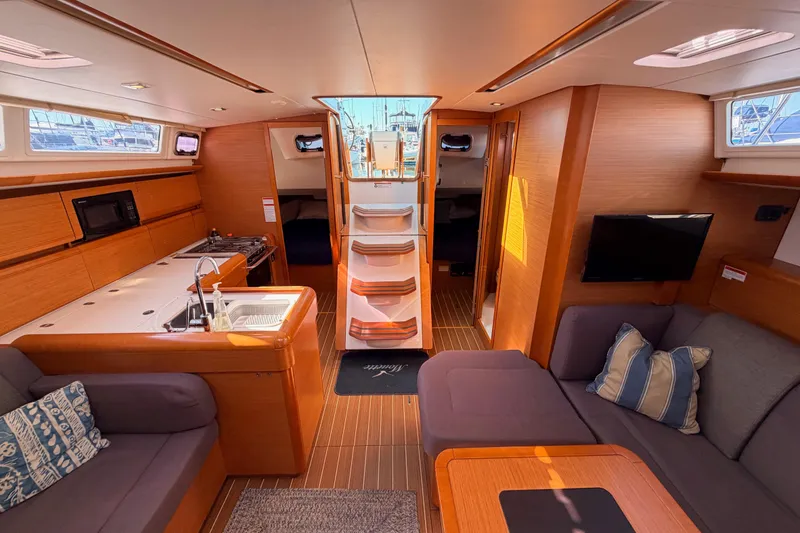 Slide: The Image of Interior of 2014 Jeanneau Sun Odyssey 469 yacht with modern kitchen and cozy seating area. - 95