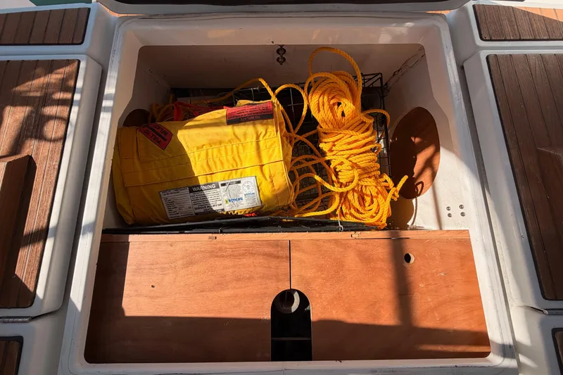 Slide: The Image of Storage compartment on 2014 Jeanneau Sun Odyssey 469 with yellow rope and safety equipment. - 97