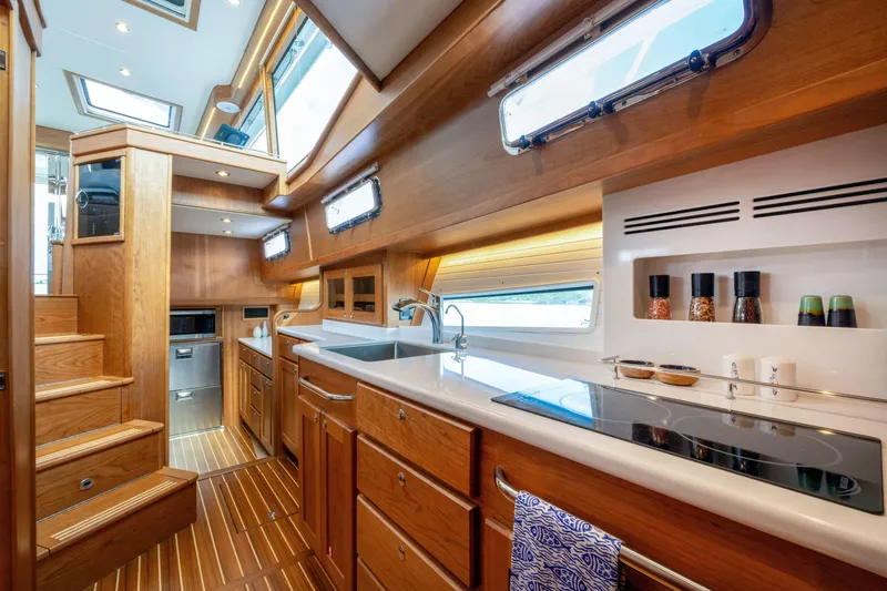 Slide: The Image of Luxurious interior of 2027 Sabre 51 Salon Express yacht with modern kitchen and wooden finishes. - 15