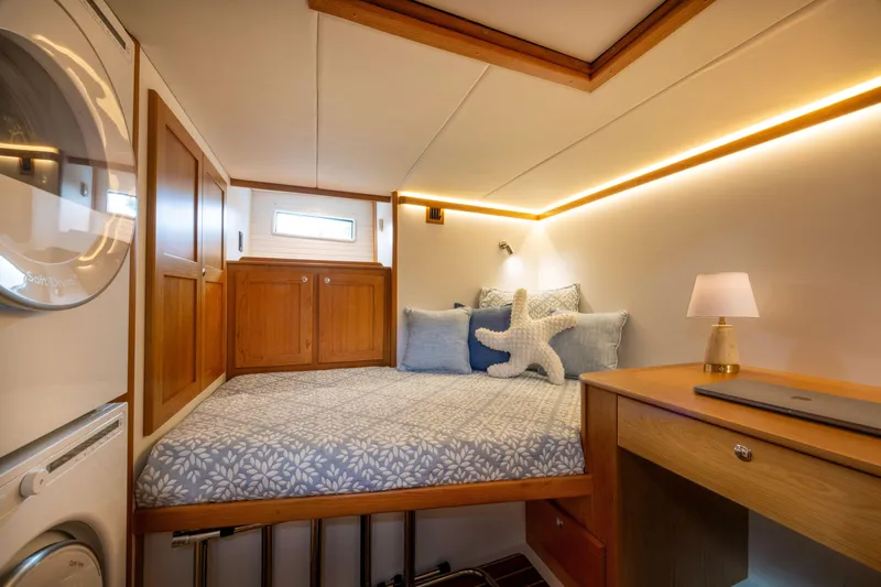 Slide: The Image of Luxurious cabin interior of 2027 Sabre 51 Salon Express with cozy bed and modern decor. - 19