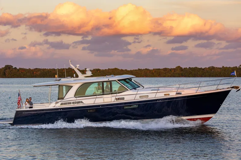 Slide: The Image of 2026 Sabre 51 Salon Express yacht cruising on serene waters at sunset. - 2