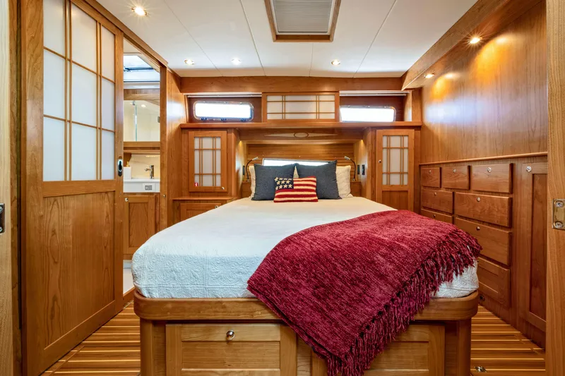 Slide: The Image of Luxurious 2027 Sabre 51 Salon Express yacht bedroom with elegant wood finish and cozy decor. - 23