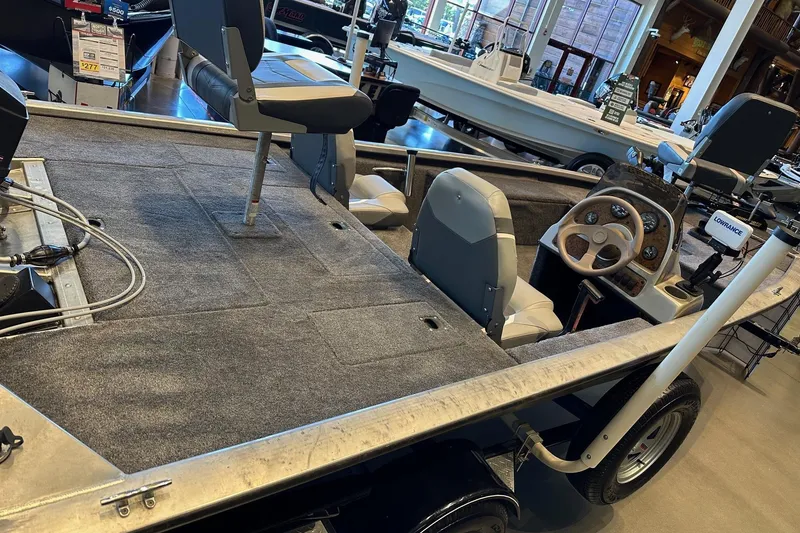 Slide: The Image of 2002 Tracker Pro Team 175 boat interior with steering wheel and seating in showroom. - 2