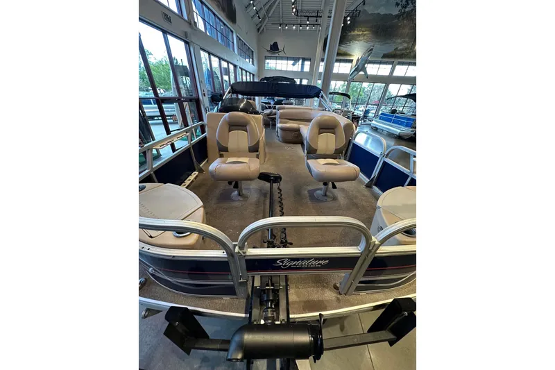 Slide: The Image of 2015 Sun Tracker Fishin' Barge 22 DLX pontoon boat interior with seating and fishing setup. - 3